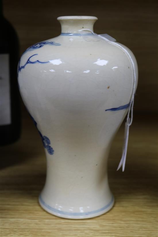 A Chinese softpaste porcelain blue and white Meiping, 18th/19th entury, wood stand Height 19.5cm